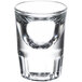 A close up of a Libbey fluted shot glass with a small bubble in it.