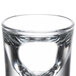 A close-up of a Libbey fluted shot glass with a white background.