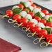 A tray of tomatoes and cheese skewers on Royal Paper Eco-Friendly Bamboo Food Picks.