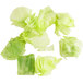 A group of diced lettuce pieces on a white background.