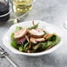 A salad with mushrooms and greens in a white Villeroy & Boch Blossom bone porcelain deep plate.