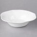 A white bowl with a small rim on a gray surface.