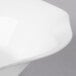 A close up of a Villeroy & Boch white bone porcelain deep plate with a curved edge.