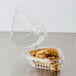 A Dart clear plastic hinged container with a slice of pie inside.