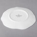 A white Villeroy & Boch bone porcelain plate with a small blossom design on it.