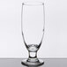 A close up of a Libbey stemmed pilsner glass with a small rim on top.