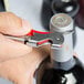 A person using the Franmara Duo-Lever Waiter's Corkscrew to open a bottle of wine.
