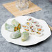 A Villeroy & Boch white bone porcelain flat plate with sushi rolls and rice paper rolls on it.