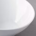 A close-up of a white GET San Michele slanted bowl with a white rim.