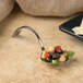 A Bon Chef curved stainless steel spoon with food in it.