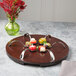 A wooden tray with Bon Chef stainless steel dessert spoons on it.