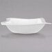 A Villeroy & Boch white bowl with a curved edge on a gray surface.