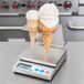 A Cardinal Detecto portion scale with removable dual cone holder trays holding two waffle cones.