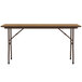 A Correll medium oak rectangular folding table with metal legs.