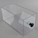 A clear plastic drawer with a black knob by Cal-Mil on a counter.