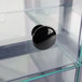 A close-up of a black knob on a Cal-Mil Soho clear drawer.
