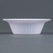 A white Fineline Flairware plastic bowl with wavy lines on it.