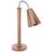 A copper coated stainless steel freestanding heat lamp with a hammered cone shade and metal base.