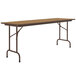 A brown rectangular Correll folding table with metal legs and a wooden top.