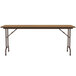 A Correll medium oak rectangular folding table with metal legs.