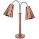 An Eastern Tabletop copper coated stainless steel freestanding heat lamp with two hammered cone shades.