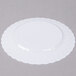 A white Fineline Flairware plastic plate with a scalloped edge.
