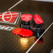 The table top of an Atomic Avenger air hockey table with red and black details.