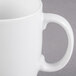 A close-up of a Libbey Alpine white porcelain mug with a handle.