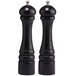 Two black cylindrical Chef Specialties pepper mills with white tops.