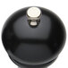 A black pepper mill with a silver knob.