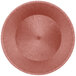 A close up of a round polyethylene basket with a brown rim.