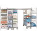 A Metro stainless steel stationary end shelving unit in a room with many items.