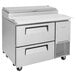 A stainless steel Turbo Air Pizza Prep Table with 2 drawers and black handles.