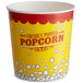 A yellow and red Carnival King popcorn bucket with white text reading "Freshly Popped Popcorn" on it.
