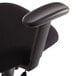 A close-up of a black OIF office chair with armrests.