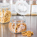 Two Libbey Garden Jars filled with pretzels and peanuts.