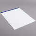 A white paper pad with blue trim.