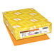A yellow package of Astrobrights Cosmic Orange paper with white and yellow letters.