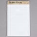 A white notepad with narrow ruled lined paper.
