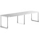 A Regency stainless steel long rectangular table mounted shelf above a white table.