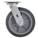 A black and gray swivel plate caster with a metal plate and wheel.