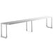 A Regency stainless steel long rectangular table mounted shelf with metal legs.