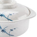 A white melamine bowl with a blue bamboo design and a lid.