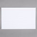 A white ruled index card with lines on it.