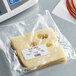 A piece of cheese in a plastic bag on a Cardinal Detecto scale.