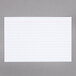A white Oxford index card with red lines.