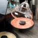 A person rimming a glass with Twang-a-Rita Paloma Love Grapefruit Rimming Salt.