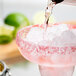 Twang-a-Rita Nectarberry Strawberry Rimming Salt being poured on a margarita.