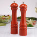 A Chef Specialties Butternut Orange pepper mill and salt mill set on a table.
