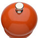The top of a Chef Specialties Butternut Orange pepper mill with a silver knob.